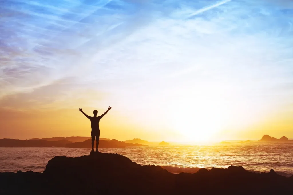 Silhouette on a coastal sunrise backdrop