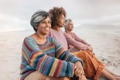 Women sitting together on the beach